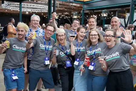 The Clearleft team celebrating at the end of the day, each one raising their drink to the camera.