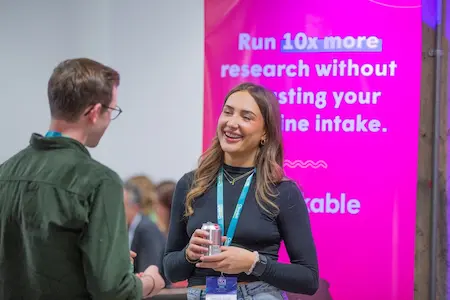 Two people chatting at a sponsor stand.