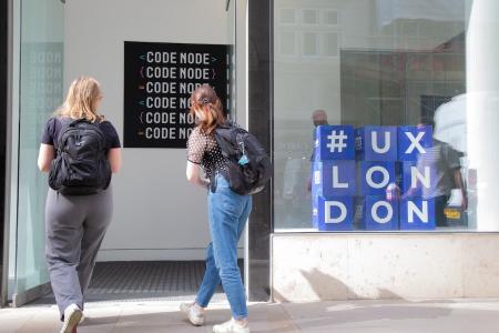 Attendees arriving at CodeNode on a bright morning.