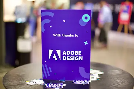 A sign on a table that reads: With thanks to Adobe Design.