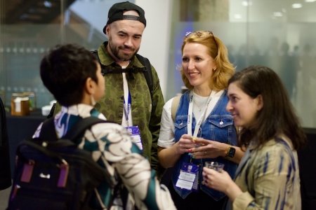 Attendees at UX London having a conversation together.