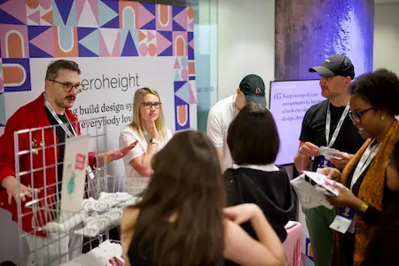 Attendees clamouring around one of the sponsor stands during a break.