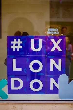 Stacked boxes in a window, each one a letter spelling out # U X L O N D O N.