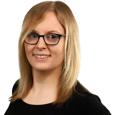 A smiling young woman with shoulder-length blonde hair wearing a dark top.