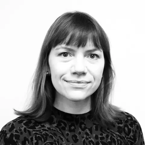 A black and white portrait of a woman with dark shoulder-length hair.