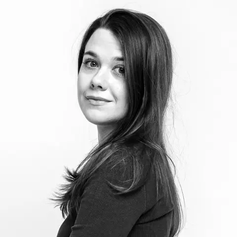 A black and white profile of a young woman with long hair.